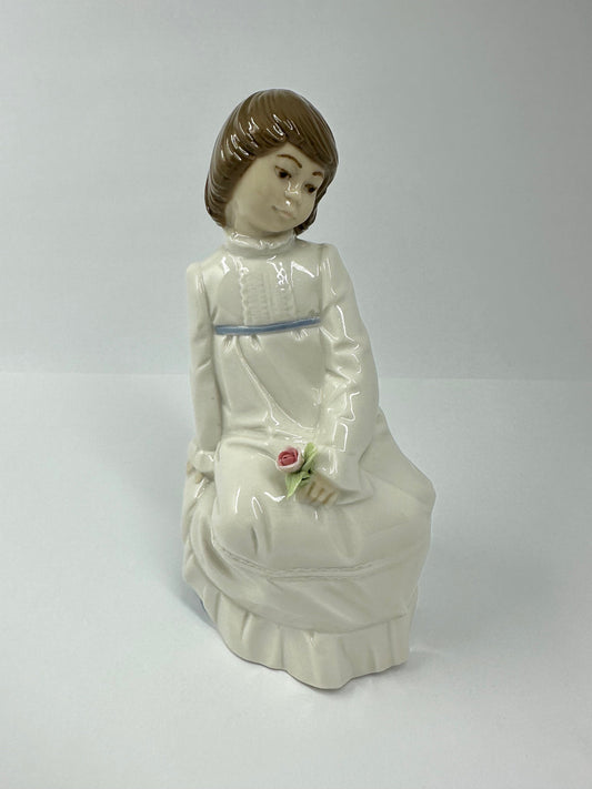 Vintage Porcelain Figurine of Young Girl Sitting Holding a Flower, by Enrique G Nadal.