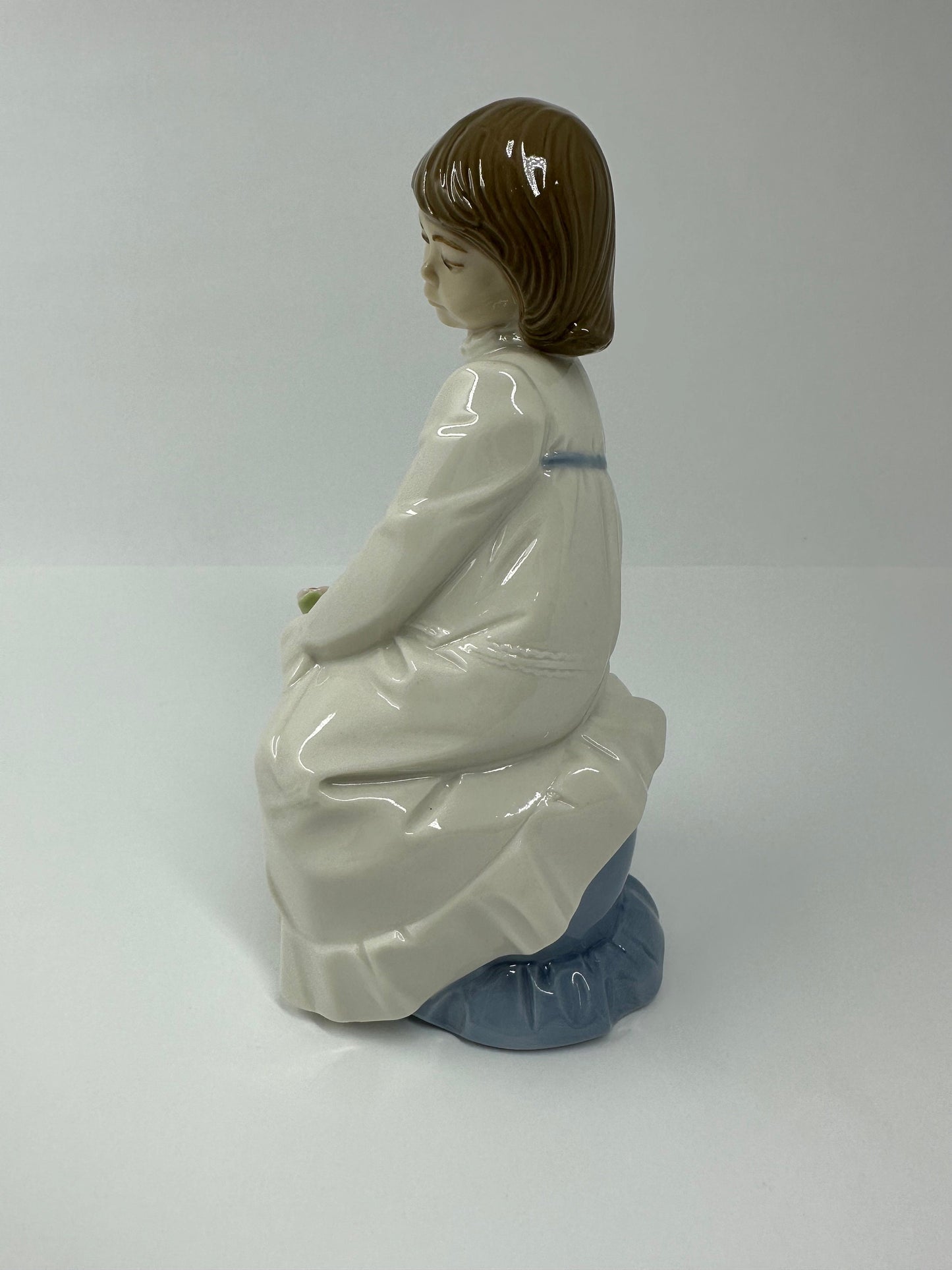 Vintage Porcelain Figurine of Young Girl Sitting Holding a Flower, by Enrique G Nadal.