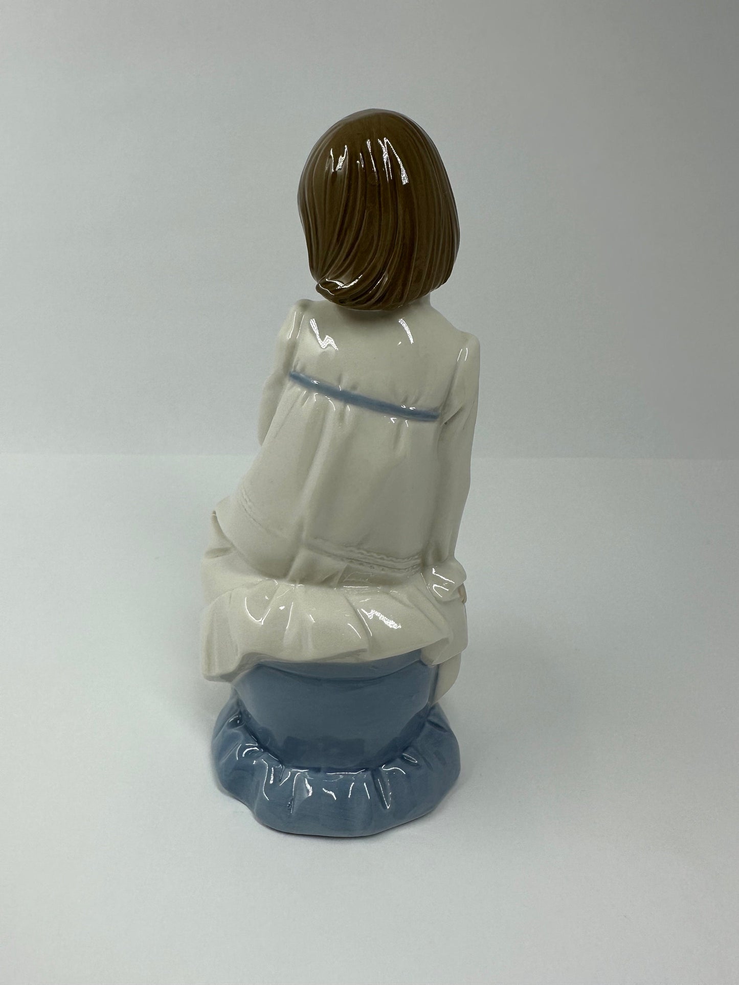 Vintage Porcelain Figurine of Young Girl Sitting Holding a Flower, by Enrique G Nadal.