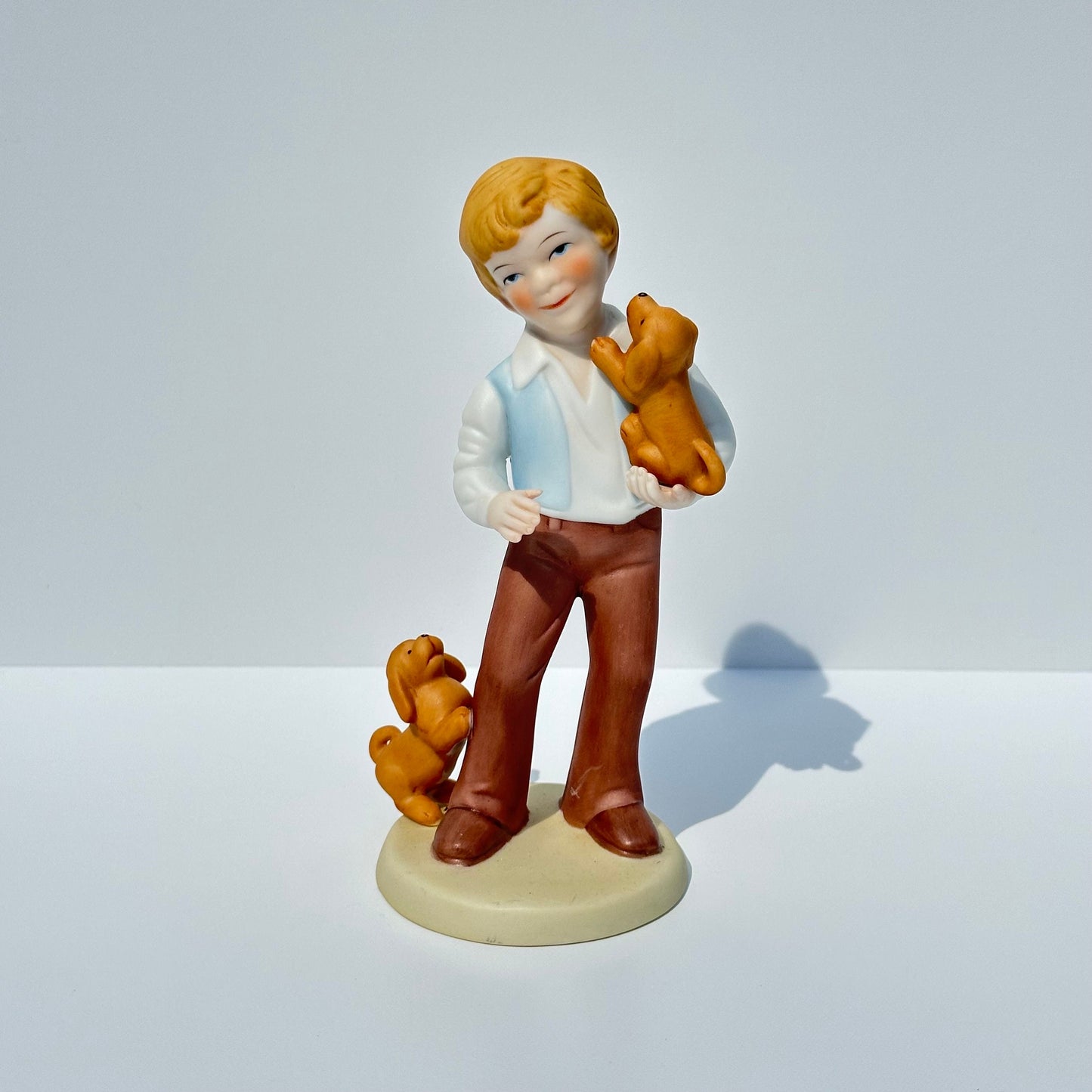 Vintage Porcelain Figurine of Boy with Puppies by Avon 1981 Collectible