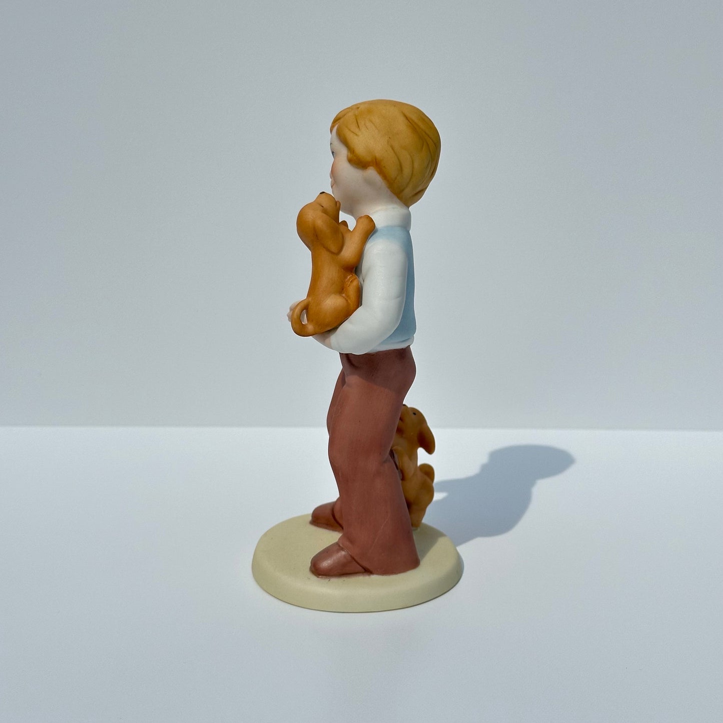 Vintage Porcelain Figurine of Boy with Puppies by Avon 1981 Collectible