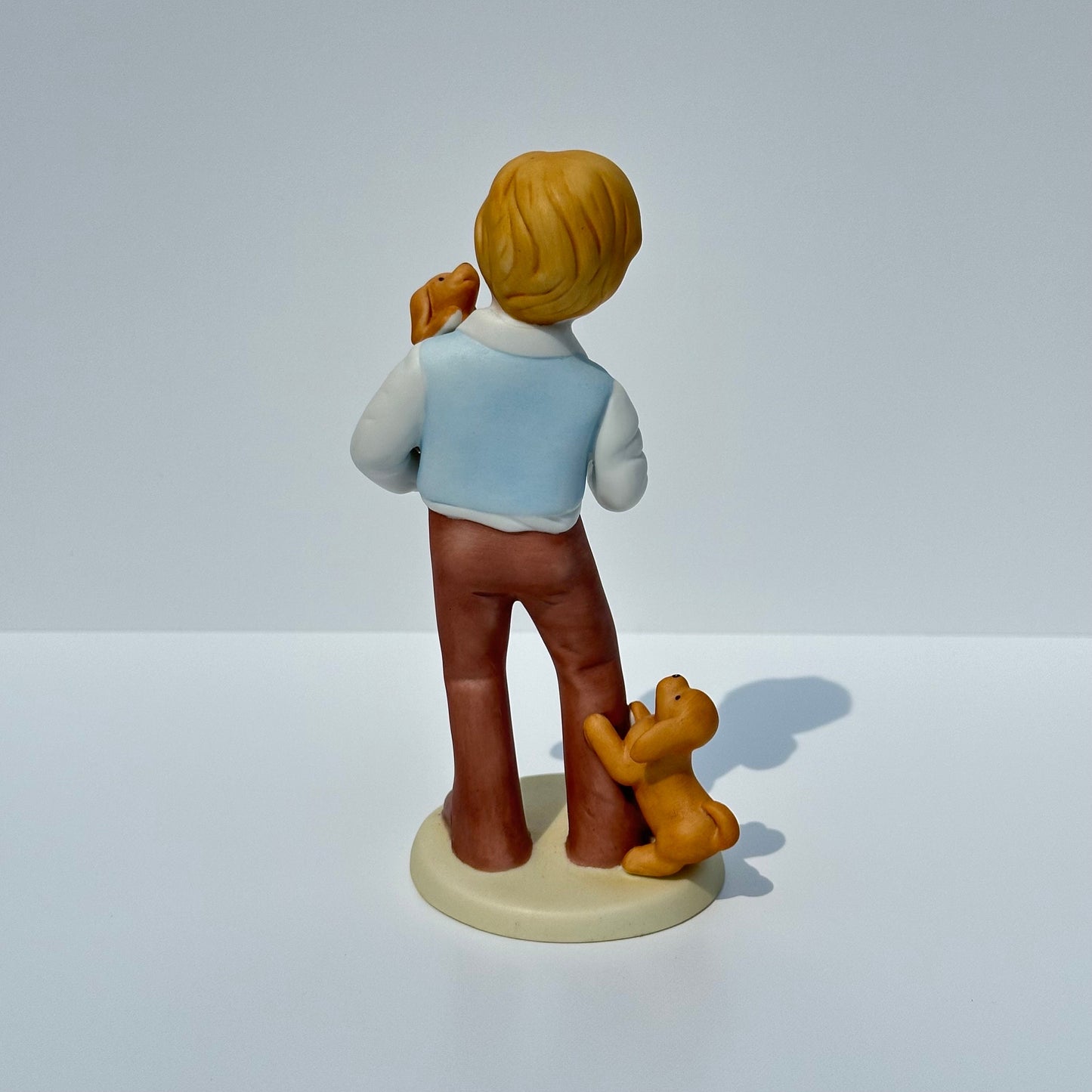 Vintage Porcelain Figurine of Boy with Puppies by Avon 1981 Collectible