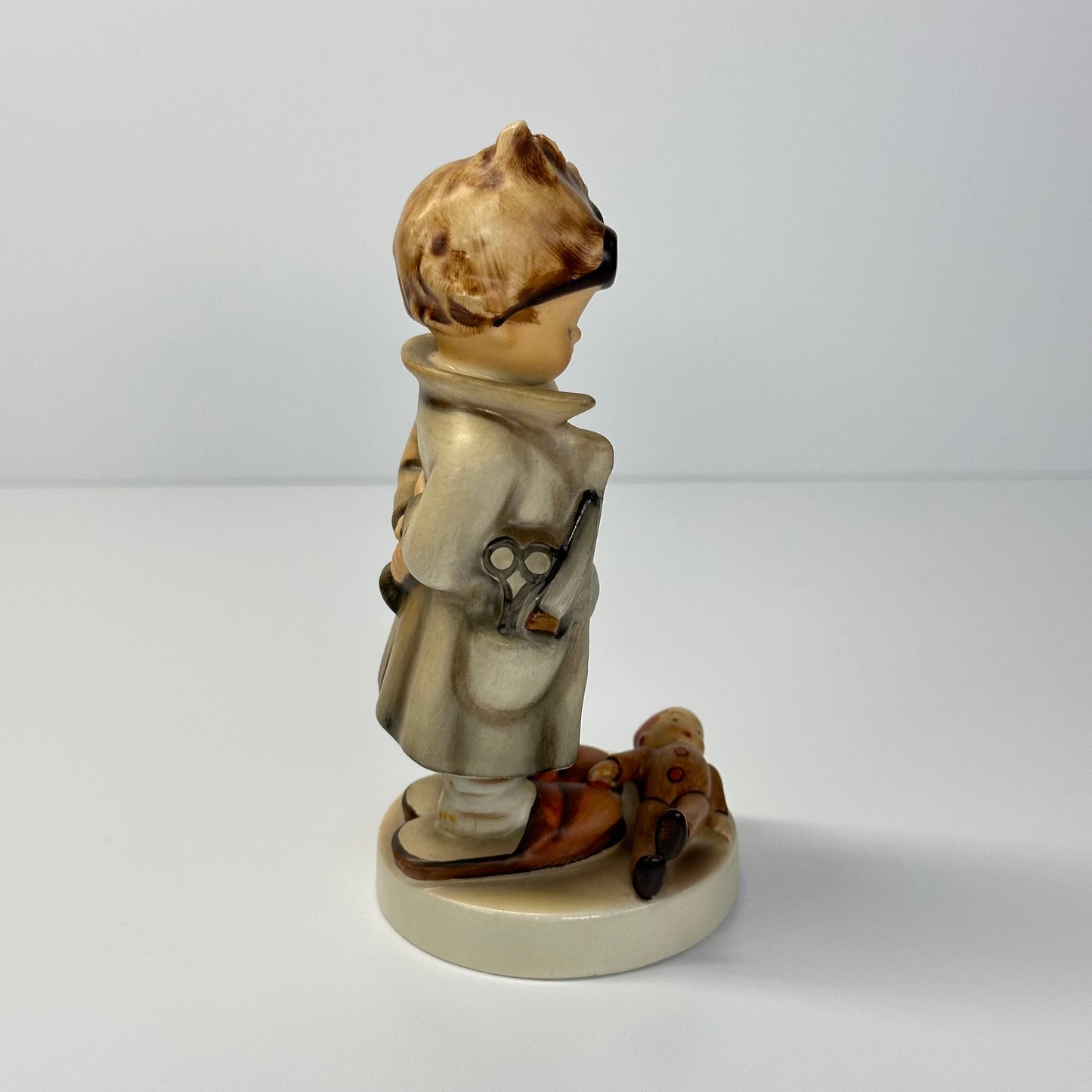 Vintage Hummel Figurine of Doctor with Doll #127 and Made in West Germany.
