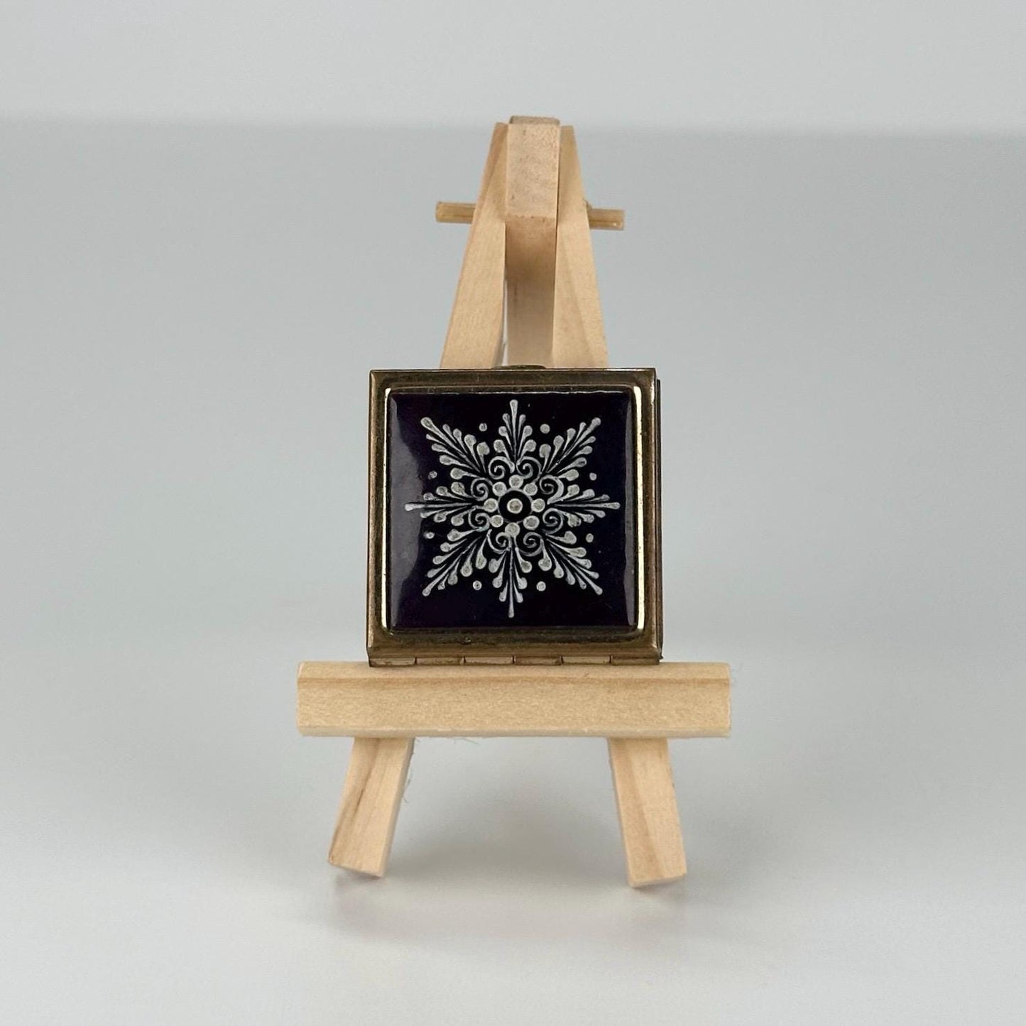 Vintage Pill Box in Gold Tone with Snowflake on a Blue Background