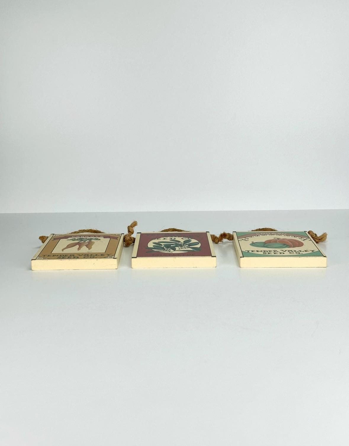 Vintage Wall Plaques of Mistletoe, Carrots, & Squash Seed Packets by Tender Valley Seed Co