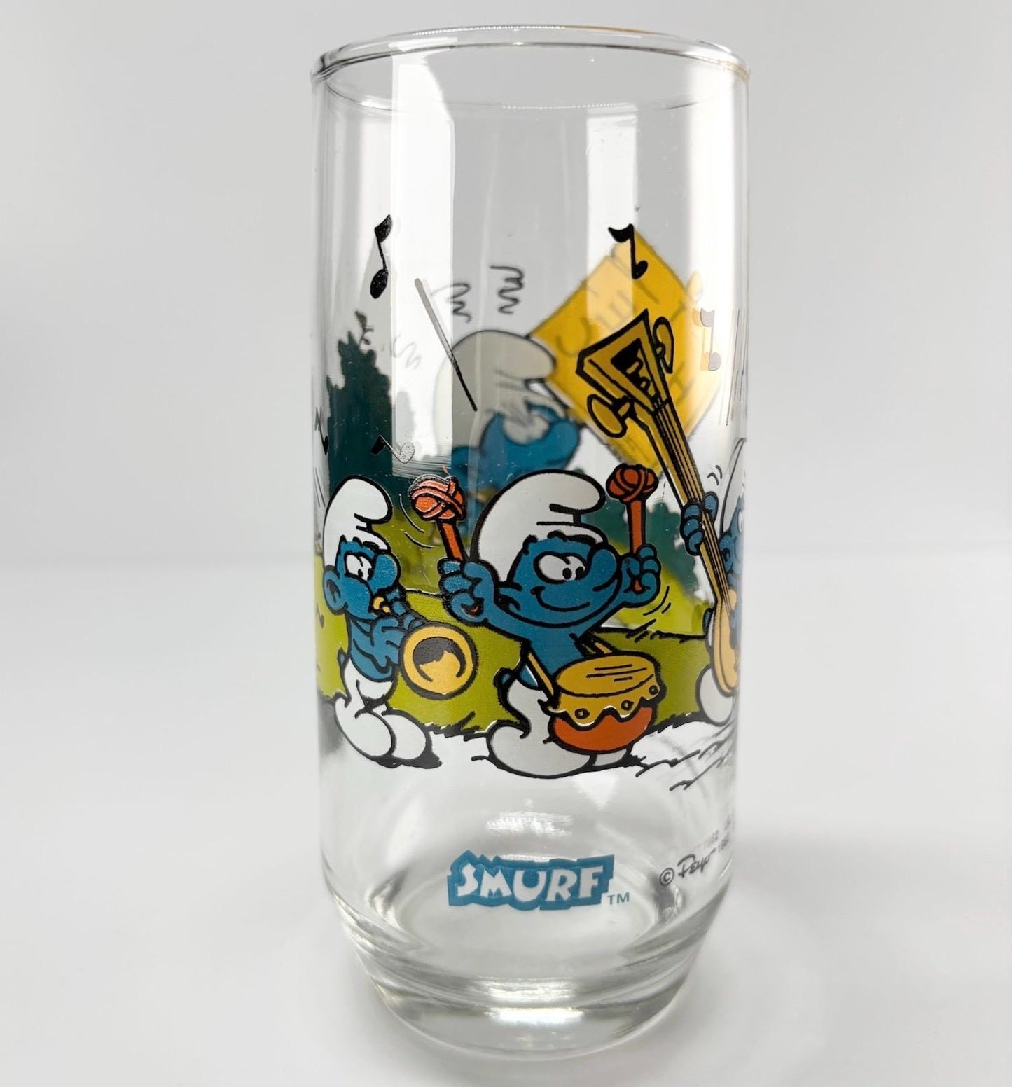 Vintage Glass of Grouchy Smurf Holding 'I Hate Music' Sign 1983