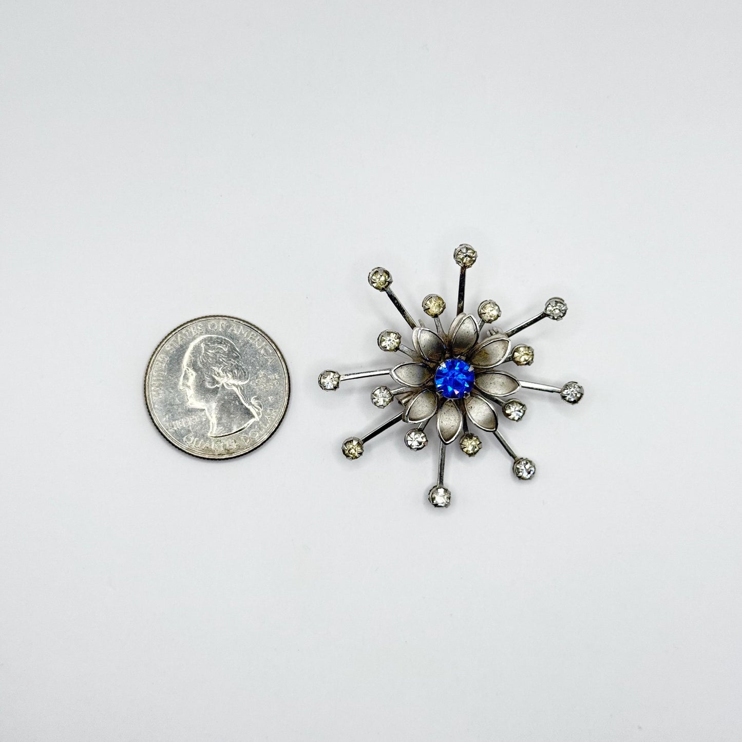 Vintage Brooch in Silver Flower Starburst Design with Blue Rhinestone Center