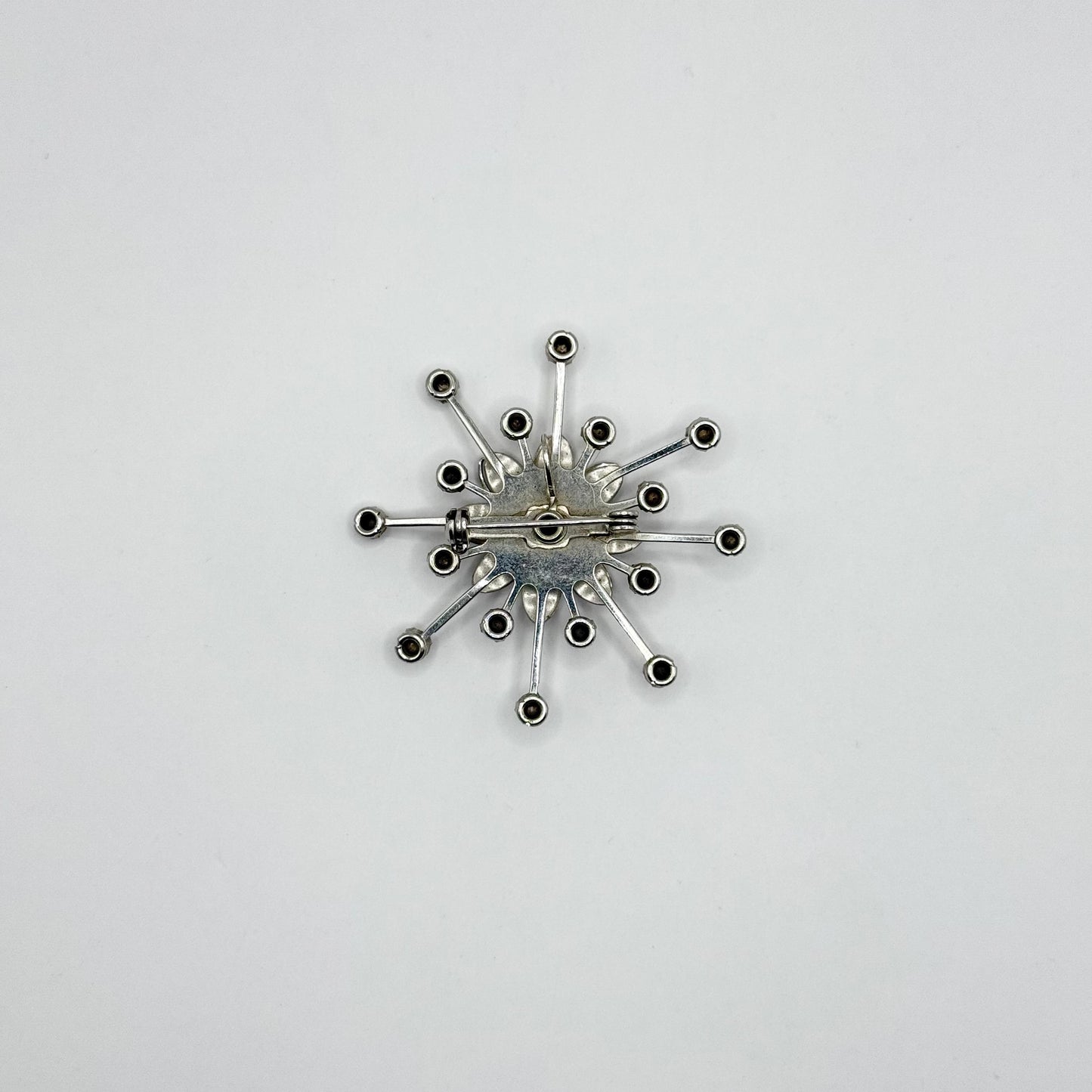 Vintage Brooch in Silver Flower Starburst Design with Blue Rhinestone Center