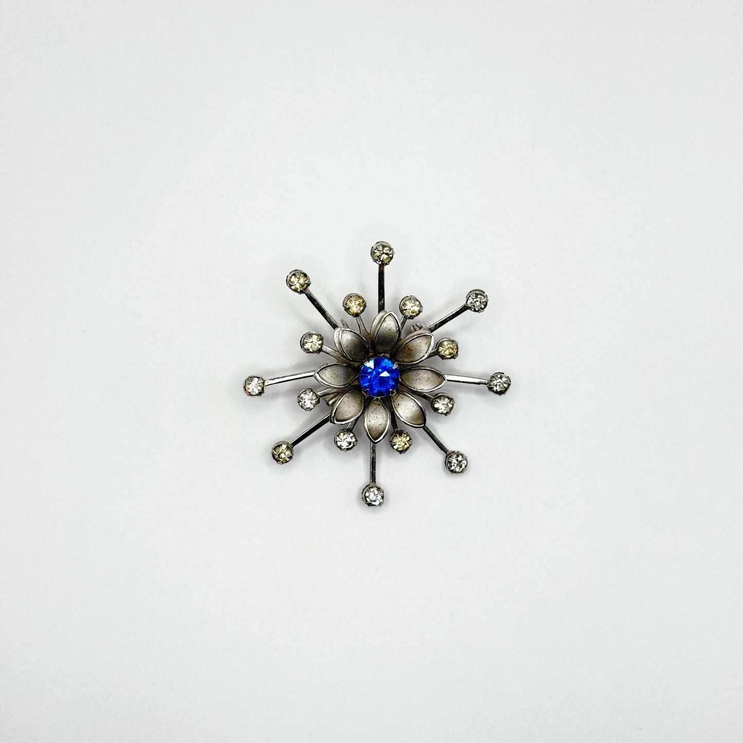 Vintage Brooch in Silver Flower Starburst Design with Blue Rhinestone Center