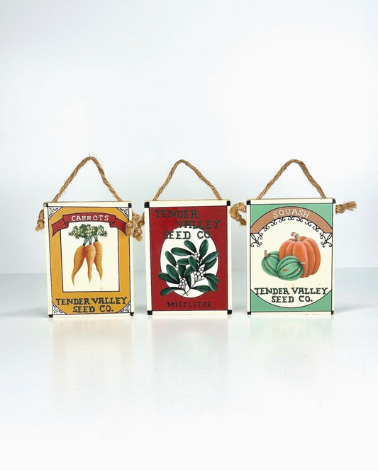 Vintage Wall Plaques of Mistletoe, Carrots, & Squash Seed Packets by Tender Valley Seed Co
