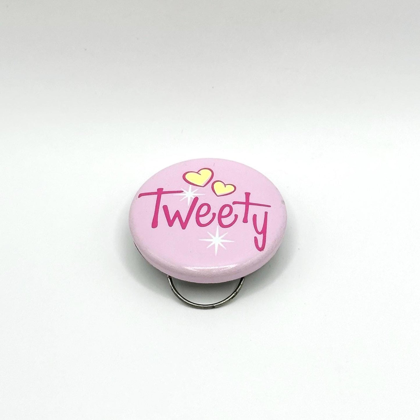 Vintage Clip On Button Reads Tweety on a Pink Background with Yellow Hearts