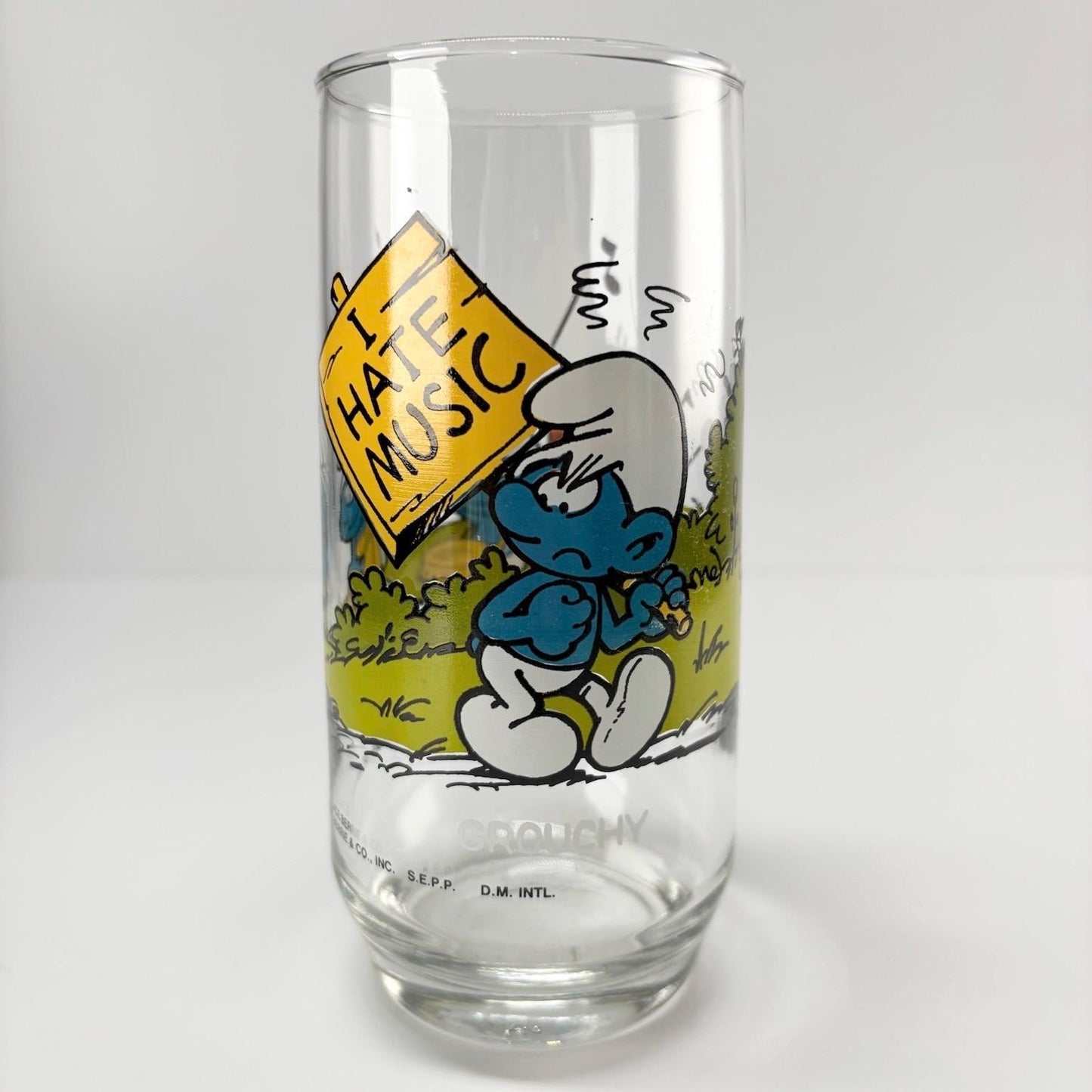 Vintage Glass of Grouchy Smurf Holding 'I Hate Music' Sign 1983